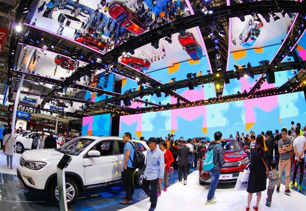 People view cars at the Beijing auto show in April. The number of passenger car sales in July was the highest monthly growth rate in at least the past 30 months. Zhang Haiyan / For China Daily