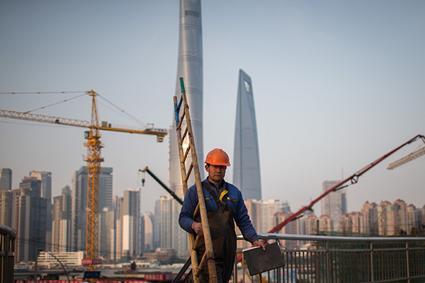 A worker walks through the construction site of a commercial property project in Pudong New Area of Shanghai. (Photo/China Daily)