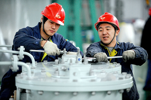 Workers from TBEA Shenyang Transformer Group Co assemble equipment in a plant in Shenyang, Liaoning province. (Photo/China Daily)