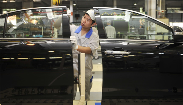 A worker at a Red Flag H7 production line of FAW Car Co Ltd in Changchun, Jilin province. The listed carmaker plans to sell the Red Flag business to its parent company. WANG HAOFEI/XINHUA