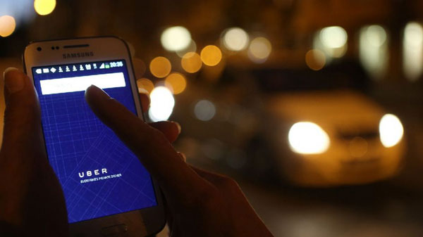 An user opens Uber app. (File photo/Xinhua)