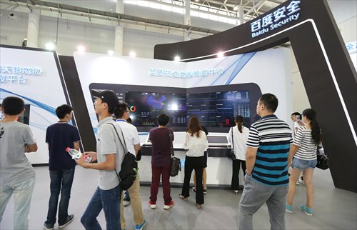 Visitors watch a screen which shows Baidu is monitoring the Internet safety of enterprises and conducting regular defense processes at the cyber security exhibition on Tuesday. (Photo: Cao Siqi/GT)
