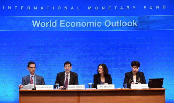 Maurice Obstfeld (2nd L), chief economist at the International Monetary Fund (IMF), attends a press briefing at the IMF headquarters in Washington D.C., the United States, Oct. 4, 2016. The International Monetary Fund (IMF) on Tuesday maintained its forecast for global growth in 2016 at 3.1 percent, saying that subpar growth will continue without determined policy action. (Photo: Xinhua/Yin Bogu)