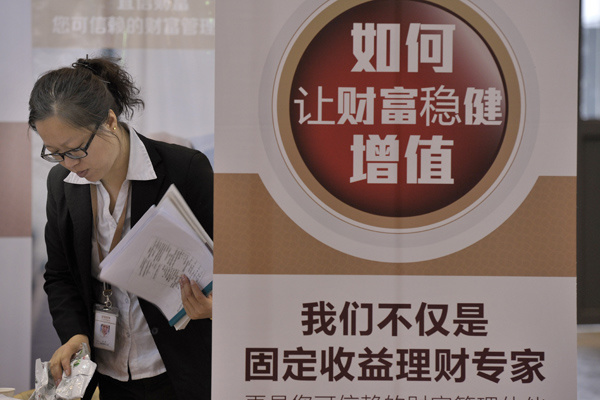 A CreditEase Corp's financial planner prepares promotional materials for her customers. (Photo by An Xin/For China Daily)