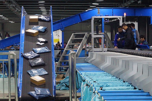 Workers monitor an auto-sorting line at a facility of ZTO Express Inc in Shanghai. Courier companies are gearing up for the upcoming Singles Day shopping festival. (Photo provided to China Daily)