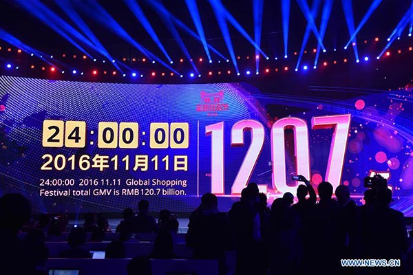 Photo taken on Nov 12, 2016 shows a giant screen displaying total gross merchandise volume (GMV) of Alibaba's online marketplace Tmall for Singles' Day shopping spree in Shenzhen, South China's Guangdong province. By 0 o'clock on Saturday, the total GMV of Tmall during Singles' Day has exceeded 120.7 billion yuan (about $17.78 billion).  (Photo/Xinhua)