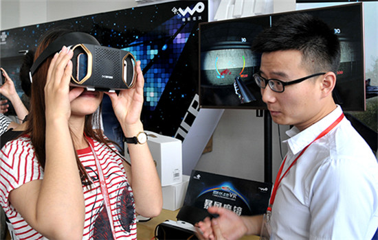 Customers try virtual reality devices at the China Unicom stand at a telecoms exhibition in Guangzhou, Guangdong province. (Photo/China Daily)