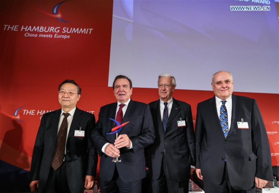 Honorary Chairman of the Hamburg Summit China Meets Europe and former German Chancellor Gerhard Schroeder (2nd L) and Li Yizhong (1st L), chairman of China Federation of Industrial Economics, pose for a photograph in Hamburg, northern Germany, Nov. 23, 2016. (Photo: Xinihua/Shan Yuqi)