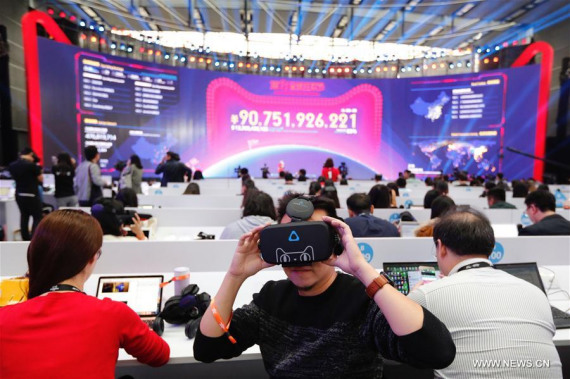 Media workers experience Buy+, the world's first virtual reality (VR) shopping store on Alibaba's online marketplace Tmall, in Shenzhen, south China's Guangdong Province, Nov. 11, 2016. (Photo: Xinhua/Shen Bohan)