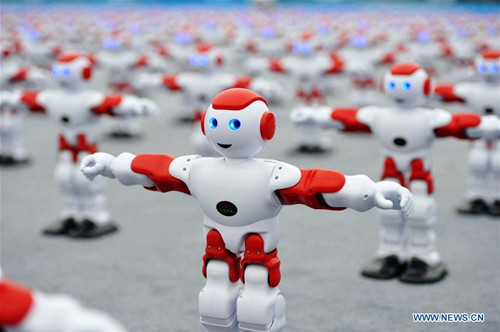 Intelligent robots dance at the main venue for 2016 Qingdao International Beer Festival in Qingdao, East China's Shandong province. A total of 1,007 robots danced together more than one minute, setting a new Guinness Record. (Photo/Xinhua)