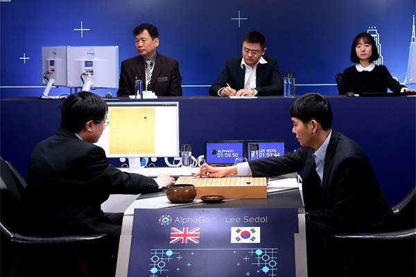 Go player Lee Sedol puts the first stone against Google's artificial intelligence program AlphaGo during the second day of Google DeepMind Challenge Match in Seoul, South Korea, March 10, 2016. (Photo/Xinhua)