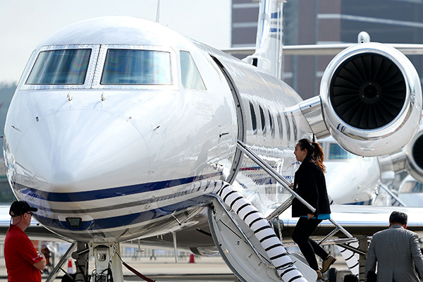 Visitors at the fourth Macao Business Aviation Expo check out a small jet on display. Participating makers of business jets from the US, France, Brazil said they received numerous enquires from potential buyers in China. (Photo/Xinhua)