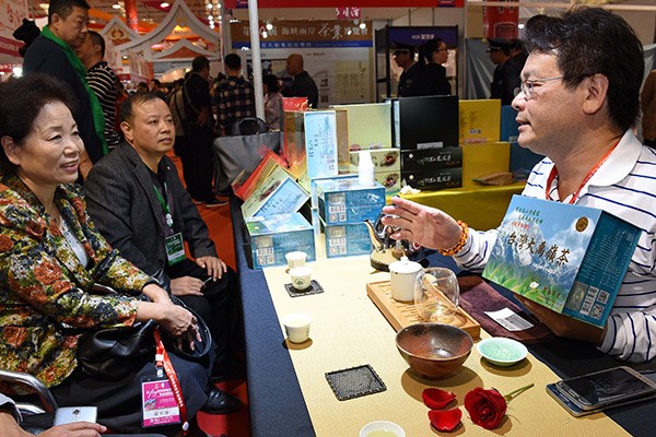 A tea merchant from Taiwan (right) showcases his tea sets at a tea expo held in Fujian province that attracted businessmen and tea lovers from across the Taiwan Straits. (Photo/Xinhua)