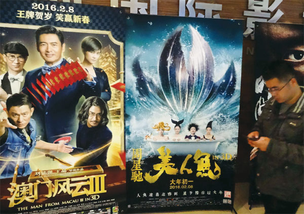 A man walks past movie posters in a mainland cinema.(Photo provided to China Daily)