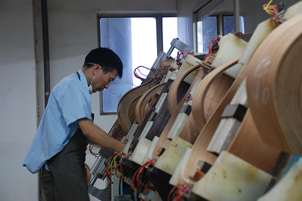A worker processes boards for guitars at a musical instrument company in Huizhou, Guangdong province. The city has more than 200 guitar-related businesses, which own more than 120 brands and produce more than 60 percent of China's guitars. (Photo/China Daily)