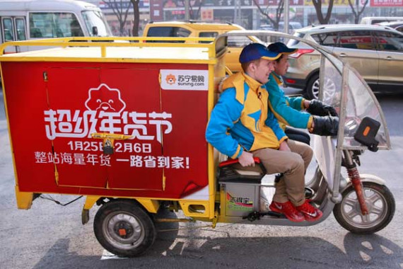 A Suning delivery vehicle on the job, transporting packages in Beijing. (Photo by Feng Yongbin/China Daily)