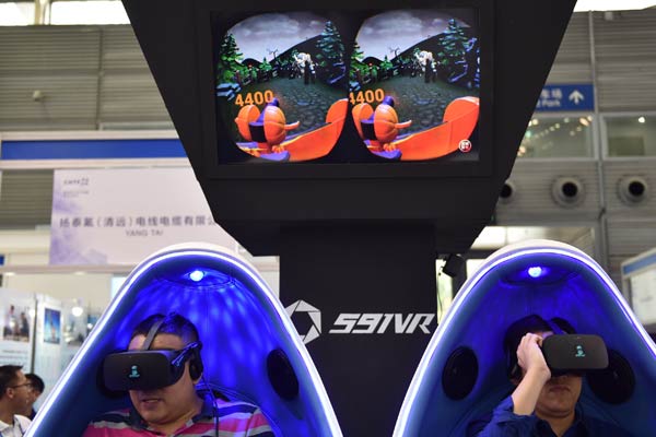 Visitors try VR games at an industry expo in Shenzhen, Guangdong province. (Photo/Xinhua)