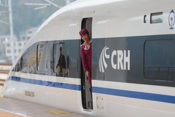 An attendant looks out a train station in Guanling, Guizhou province. Guanlin is one of the stations on the Shanghai-Kunming high-speed railway. (Photo by Zou Hong/China Daily)
