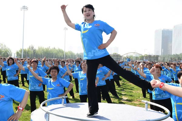 Dancers perform in Shenyang, Liaoning province. More than 310,000 people took part in a national square dancing gala in May in six cities, which created a Guinness World Record. (Photo by Wang Huan/For China Daily)