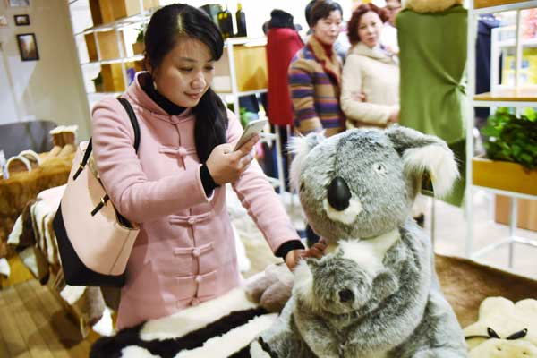 A woman chooses toys from Australia in Hangzhou, Zhejiang province. (Photo by Long Wei/For China Daily)