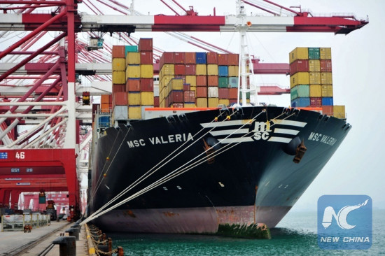 A cargo vessel anchors at the foreign trade container wharf of Qingdao Port in east China's Shandong Province, Oct. 13, 2016. (Xinhua/Yu Fangping)