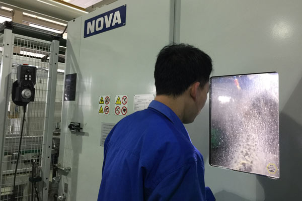 A worker tests a new production line for train bearings in ZWZ Group's factory in Wafangdian, Northeast China's Liaoning Province, Jan. 12, 2017. (Photo/chinadaily.com.cn)