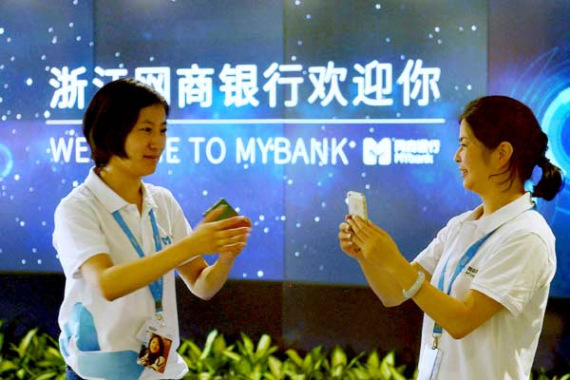 Employees collect memorabilia in the form of digital images at MYbank's launch in June 25, 2015. (Photo China Daily/Long Wei)
