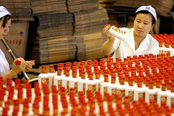 Workers pack bottles of Moutai, a fiery Chinese liquor, at the Kweichow Moutai Co Ltd plant in Guizhou province in May 2016. (Photo by Jiang Dong/Chna Daily)