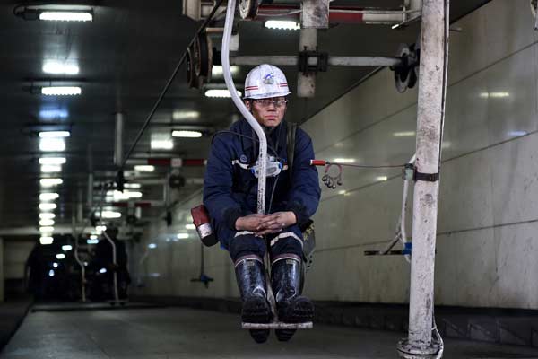 A miner takes an overhead man-riding device to come out of a mine of Shanxi Jincheng Anthracite Coal Mining Group in Jincheng, Shanxi province. (Photo/Xinhua)