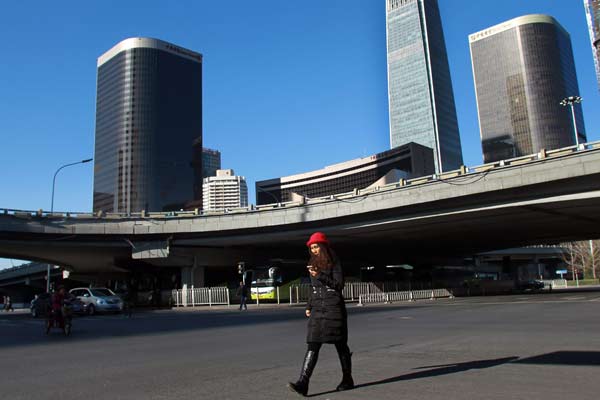 A woman saunters through the central business district of Beijing. (Zou Hong/China Daily)