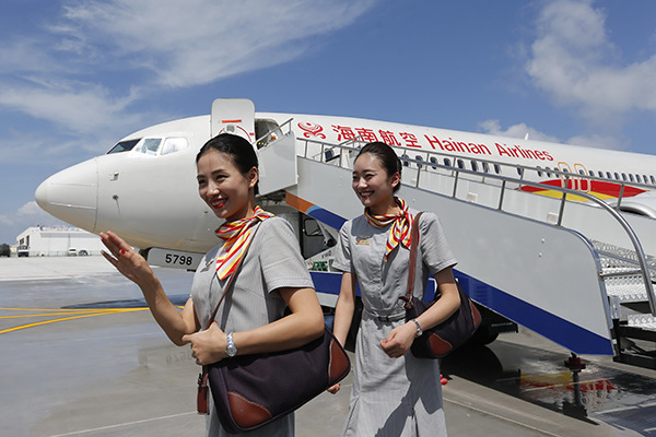 Crew members get off a plane of Hainan Airlines, a subsidiary of HNA Group Co, after landing at Nansha Islands. (Photo provided to China Daily)