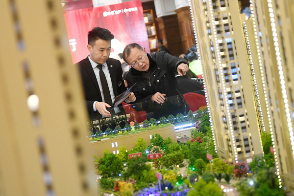 A potential homebuyer checks out a property project in Taiyuan, Shanxi province, on Wednesday. WEI LIANG / CHINA NEWS SERVICES