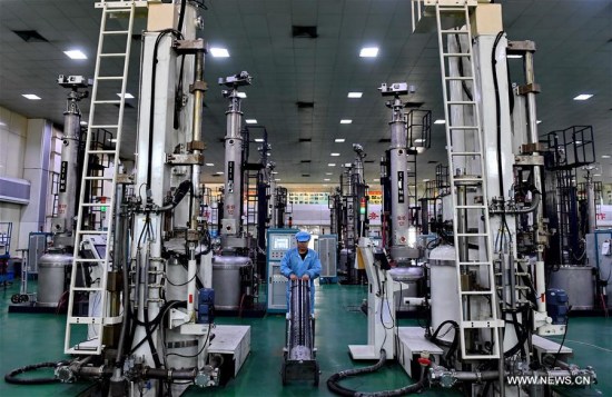 Photo taken on Feb. 24, 2017 shows a worker carrying a monocrystalline silicon stick at a factory in Ningjin County, north China's Hebei Province. (Xinhua/Mu Yu)
