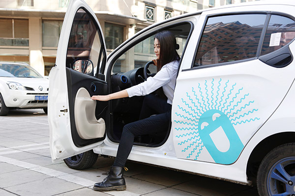 A woman is about to test-drive a new energy car provided by Gofun, the car-sharing arm of Beijing Shouqi Group. (Photo provided to China Daily)