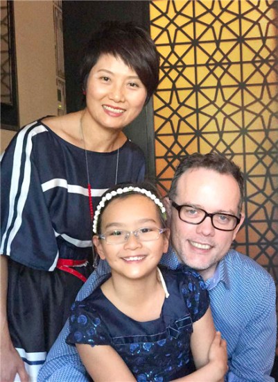 Australian businessman Vaughn Barber says he enjoys his lifewith his wife and daughterin Beijing. (Photo provided to China Daily)