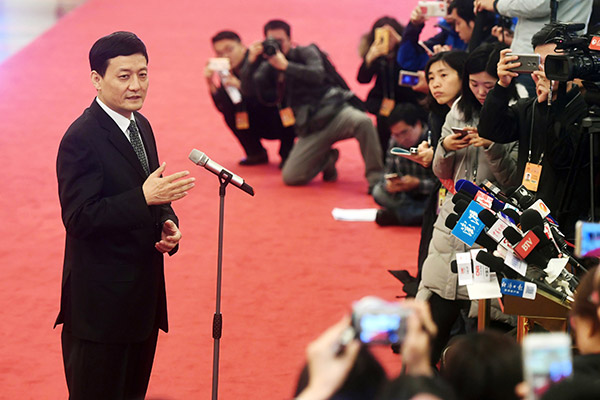 Xiao Yaqing, chairman of the State-owned Assets Supervision and Administration Commission, answers reporters' queries on the sidelines of the two sessions in Beijing. (Photo/Xinhua)