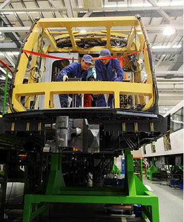 Technicians adjust parts in a metro train in an assembly plant in one of CRRC's subsidiariesCRRC Zhuzhou Electric Locomotive Coin Zhuzhou, Hunan province. (Photo/Xinhua)