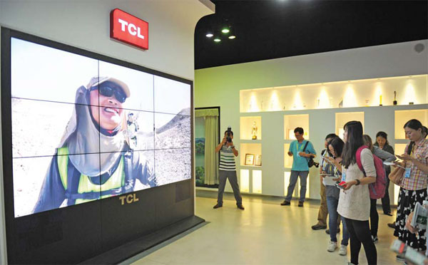 Visitors experience the new products at TCL's headquarter in Huizhou, Guangdong province. (Photo/China Daily)