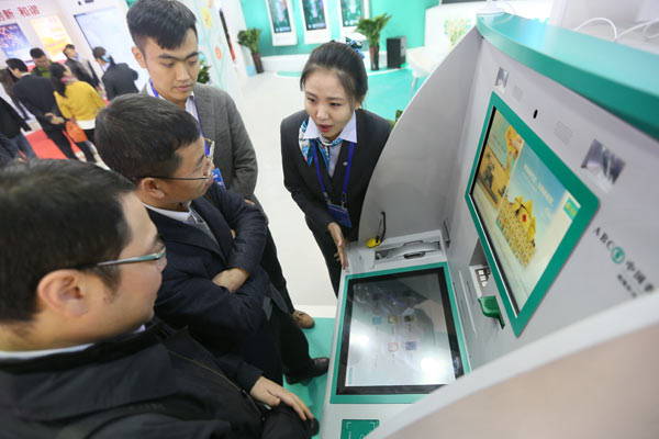 Vistors check out the booth of Agricultural Bank of China at the 12th International Financial Expo in Beijing. (Photo by A Qing/For China Daily)