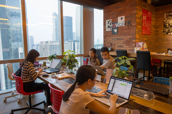 Startup teams share work space at an office-sharing community in Guangzhou, Guangdong province. (Photo by Tan Qingju/For China Daily)