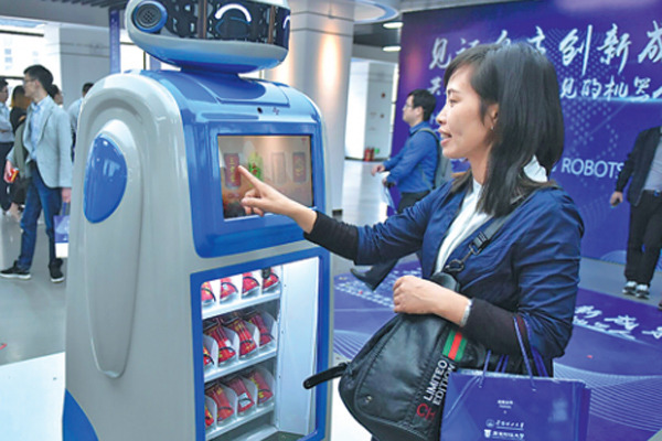 A woman interacts with a smart Magic Wand vendor in Guangzhou. (Photo by Zhu Yuanbin/China Daily)