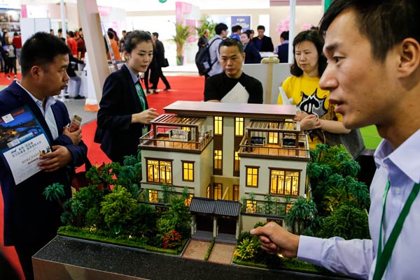 Potential property buyers visit the spring home fair in Beijing on Friday. (Photo by Kuang Linhua/China Daily)