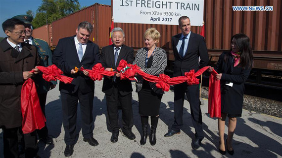 Deputy Secretary of State Tamas Molnar (5th R), who is responsible for customs and international affairs of the Ministry of National Economy and Duan Jielong, Chinese Ambassador to Hungary (4th R) cut a ribbon at the welcoming reception of a China-Europe freight train at Budapest, Hungary, on April 21, 2017. The first freight train from Xi'an, China to Budapest arrived here on Friday. (Xinhua/Attila Volgyi)