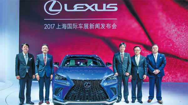 Lexus executives pose with the new Lexus NX mid-size SUV at its world premiere during the Shanghai Auto Show on April 19, 2017. (Photo provided to China Daily)