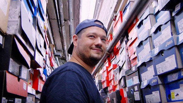 John McPheters, Stadium Goods' co-founder and CEO, at a storehouse of KAWS X Air Jordan 4 sneakers. This New York City-based sneaker startup launched a flagship store on Tmall Global in 2016. PROVIDED TO CHINA DAILY
