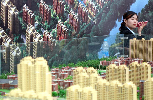 A saleswoman at a real estate show in Zhengzhou, Henan province. XINHUA