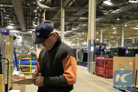 A worker records data at Fuyao Glass America's new facility in Moraine, Ohio, the United States on Oct. 7, 2016. Fuyao Glass America is part of Fuyao Industry Group Co. Ltd., a leading international manufacturer of automotive and industrial glass located in China.(Xinhua/Wang Naishui)
