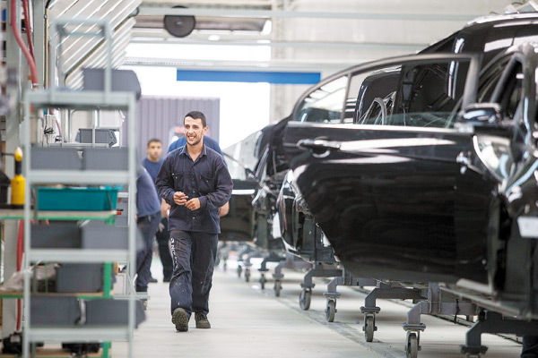 Workers check auto parts at Geely's plant in Montevideo, Uruguay. XU ZIJIAN / XINHUA