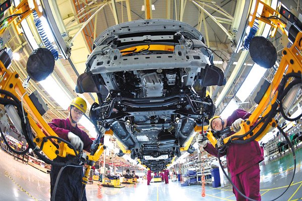 Workers assemble new cars at a production line at JAC Motor's plant in Bozhou, Anhui province. LIU LIQIN / FOR CHINA DAILY