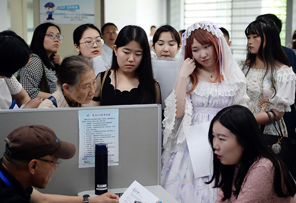 Students, some in costume, attend a career fair in Nanjing, Jiangsu province, earlier this month. CUI XIAO/CHINA DAILY
